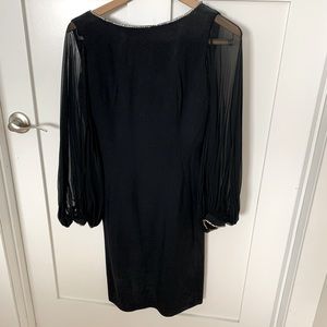 Black vintage dress. Small 2 or 4 size knee length with sleeves & diamond detail